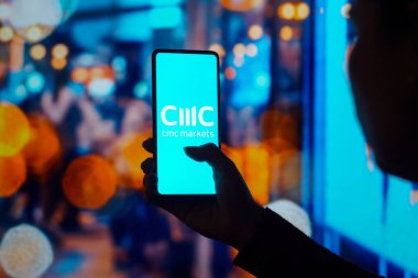 July 27, 2022, Brazil. In this photo illustration, the CMC Markets logo is displayed on a smartphone screen