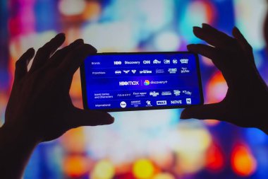 August 5, 2022, Brazil. In this photo illustration, the HBO Max and Discovery Plus logos is displayed on a smartphone screen. Warner Bros. Discovery announced that streaming platforms will be unified