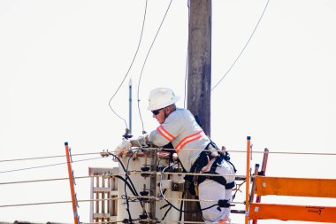 August 23, 2022, Brazil. In this photo illustration, Energisa electrician climbs a pole to fix power wires in Mato Grosso do Sul