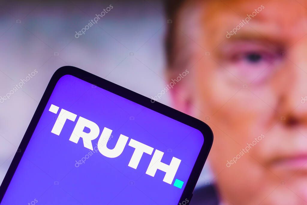 September 22, 2022, Brazil. In this photo illustration, the social media platform Truth Social logo seen displayed on a smartphone with a photo of former US President Donald Trump displayed in the background