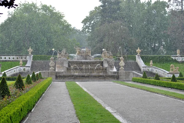 Heavy summer rain in a park — Stock Photo, Image