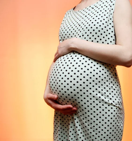 Pregnant Girl Stands Hugging Her Belly — Fotografia de Stock