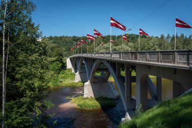Bridge over Gauja River with Latvian Flags - Sigulda, Latvia clipart