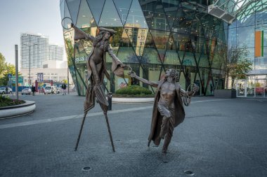 Bratislava, Slovakia - Oct 14, 2019: Olga and Pat sculpture in front of  Eurovea Galleria Shopping Mall by Colin Spofforth, 2013 - Bratislava, Slovakia