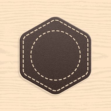 retro vintage tarzı boş deri rozeti. Altıgen şekil ahşap doku desen arka plan üzerinde yuvarlanır. Şablon kalacaksınız ve premium kalite etiketleri