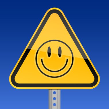 Yellow road warning sign with smiley face symbol on sky background clipart