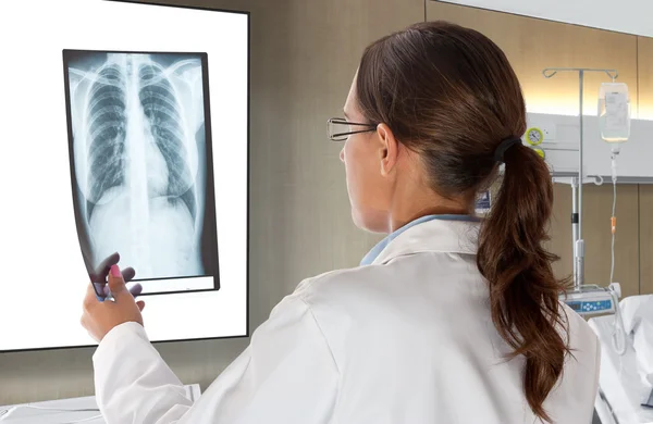 Mujer doctor mirando radiografía de rayos X — Foto de Stock