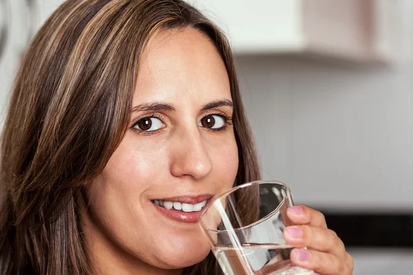 Kvinnan leende med ett glas vatten — Stockfoto