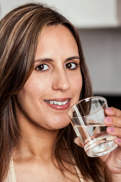 Woman smiling with a glass of water — Stock Photo, Image