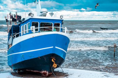 2021, 25 Aralık, Polonya, Ustronie Morskie - Kıyıdaki mavi balıkçı teknesi