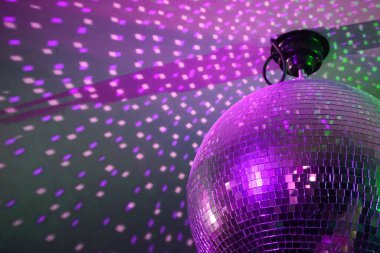 Round disco ball, light reflections on a ceiling