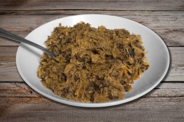 Fried cabbage with mushrooms on plate