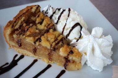 Slice of apple pie and whipped cream