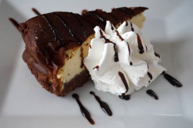 Triangular slice of cake with whipped cream