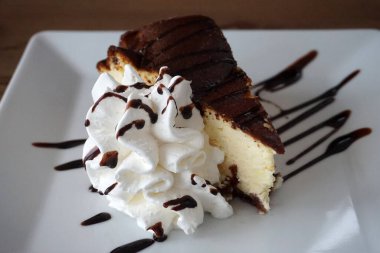 Triangular slice of cake with whipped cream