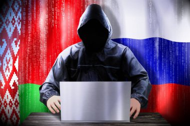 Anonymous hacker working on a laptop, flags of Belarus and Russia clipart