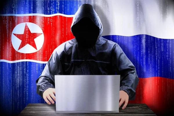 Hacker Anónimo Trabajando Una Computadora Portátil Banderas Corea Del Norte —  Fotos de Stock