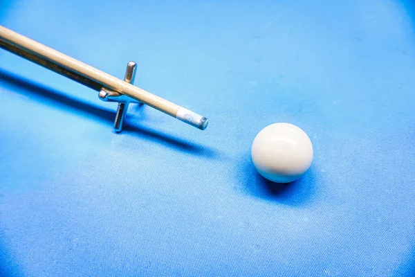 Billiards game - white ball and a cue