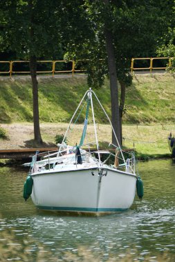 Sailboat swimming with an engine - front view
