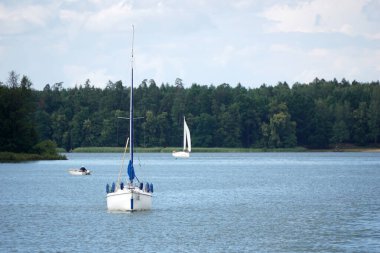 Sailboat swimming with an engine - front view