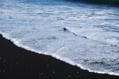 Reynisfjara - black beach in Iceland, close-up on waves