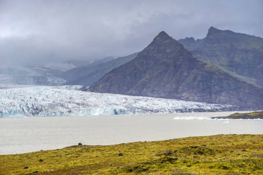 Fjallsarlon Iceberg Lagoon in Iceland - glacier, ice floes, mountains and lake shore