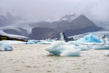 Fjallsarlon Iceberg Lagoon in Iceland - glacier, ice floes and mountains - hdr photograph
