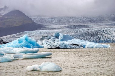 Fjallsarlon Iceberg Lagoon in Iceland - glacier, ice floes and mountains - hdr photograph