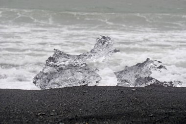 Block of ice on a black, volcanic shore - Diamond Beach in Iceland