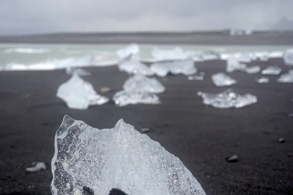 Blocks of ice laying on black volcanic sand - Diamond Beach, Jokulsarlon, Iceland