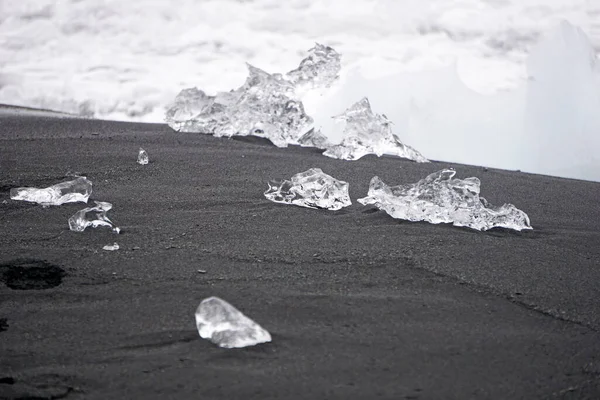 Blocks of ice laying on black volcanic sand - Diamond Beach, Jokulsarlon, Iceland