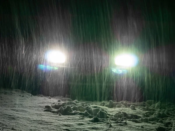 Snow blizzard in the light of car headlights on the night road. — 图库照片#