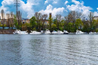Dinyeper Nehri 'ndeki nehir eğlence tekneleri için demirleme yeri. Tekneler için park yeri. Gemi iskelesi. Nehir kıyısında. Kıyı şeridi. Su nakli. Kiev 'deki Dinyeper Nehri. Su akışı.