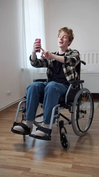 A beautiful disabled man is talking with his friend on the Internet — Stock Photo, Image