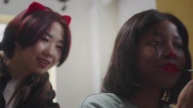 Güzel bir bayan cadılar bayramı makyajı çiziyor.