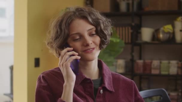 Eine junge Frau telefoniert mit jemandem — Stockvideo