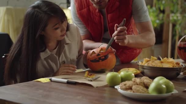 Young Man Teaches Lady How Carve Eyes Halloween Pumpkin High — Stock Video