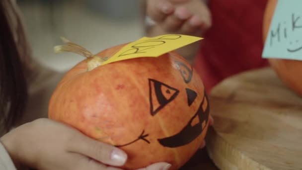 Named Halloween pumpkins on the table close-up — Stock Video