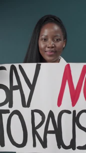 Schöne Afroamerikanerin hält stolz ein Stop Rassismus Schild — Stockvideo