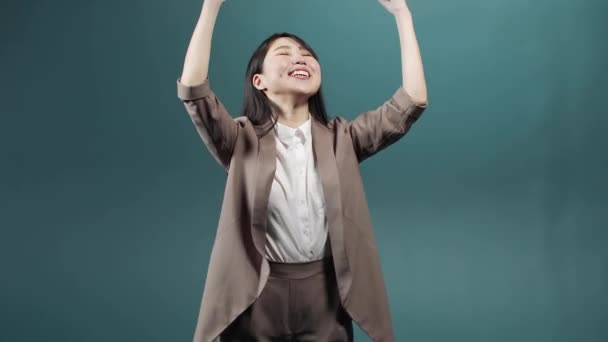 An asian pretty lady wearing a jacket with a blouse is standing and rejoicing for the accomplished event — Stock Video