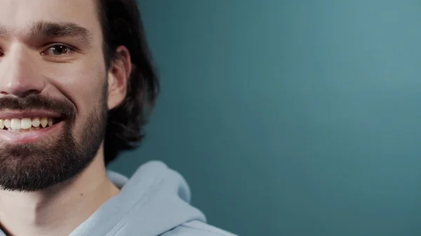 Carefree attractive guy with dark hair and beard sincerely smiling — Stock Photo, Image