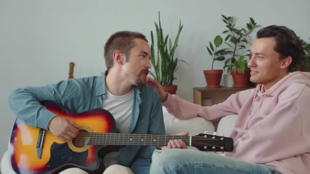One Lgbt Men Showing Skills Playing Guitar His Boyfriend Another — Stock Video