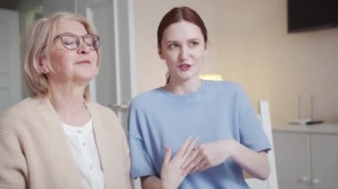 Genç bir kadın ve girişimci büyükannesi tripodun üzerinde telefonun önünde bir masada oturuyorlar. Kağıt üzerine çizilmiş çizelgeler ve grafikler kullanarak sermaye yatırımından bahsediyorlar. Yüksek kalite