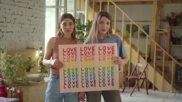 Two Attractive Young Girls Standing Studio Showing Lgbt Poster Camera — Stock Video