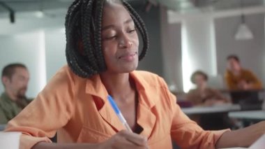 Mola sırasında, öğretmen öğrencilerini izliyor ve onlara gülüyor, yavaş çekimde yakından. Yüksek kalite 4k görüntü