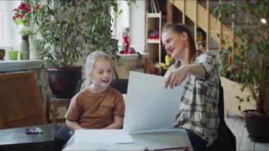 Çocuk ve kadın çizim yapıyorlar. Öğretmen çizmeye başlar ve kızdan tekrar etmesini ister. Yüksek kalite 4k görüntü