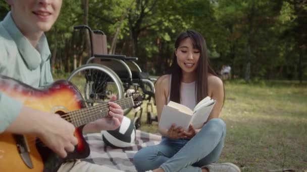 Sitting Plaid Public Park Young Disabled Man Playing Guitar While — Stockvideo