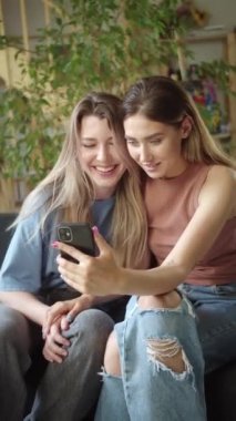 Two young lgbt ladies are talking news about their wedding to their relatives on the video call. High quality FullHD footage