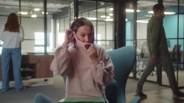 An attractive cheerful young lady is putting on medical mask for health protection and prevention during the virus outbreak, epidemic and infectious diseases. High quality 4k footage