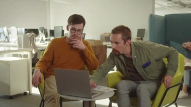 Two handsome young students are representing their paper project to the professor on the video call. High quality 4k footage